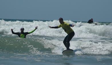 Progress Surf School man learning to swim with instructor
