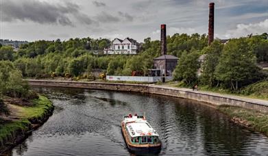 Swansea Community Boat sailing past copperworks