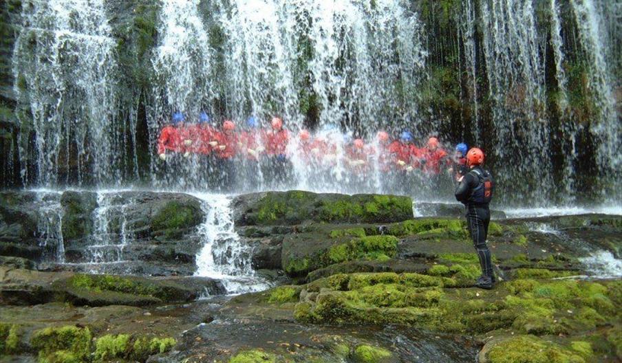 Adventure Britain people under waterfall