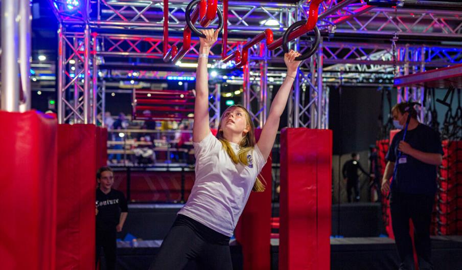 An image of a woman hanging from a bar