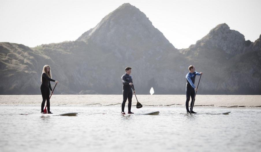 The Sup Hut man woman and boy using paddle boards