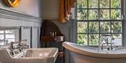 The bath and two sinks in the elegant bathroom of Heart of Oak deluxe room