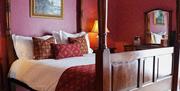 A four-poster bed and elegant artwork in the centre of the bedroom