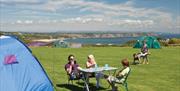 A photograph of a group of people camping at Greenways of Gower