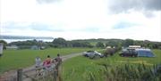 A photograph of a group of people camping at Greenways of Gower