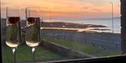 Two glasses of champagne placed on a window sill