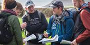 A group of people holding maps