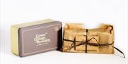 A Gower Cottage Brownies tin and package wrapped and tied with a bow