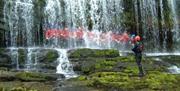 Adventure Britain people under waterfall