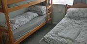 Bunk beds and single bed in a room.