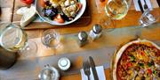 Two people eating a meal at the Beach hut Cafe