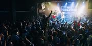 Crowd watching a band on stage.