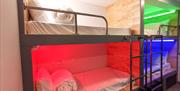 Cwtsh Hostel bunkbeds lit up