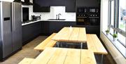 Cwtsh Hostel dining area and kitchen