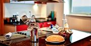 Meridian Quay Apartments kitchen area with welcome hamper