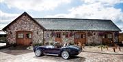 Mulberry House exterior with vintage race car