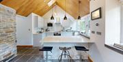 Traditional farmhouse kitchen with flag floor and modern units