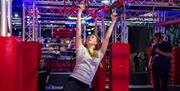 An image of a woman hanging from a bar