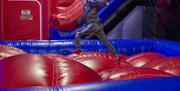 Ninja Warrior boy running along inflatables