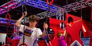 Ninja Warrior boys on climbing frame and ropes