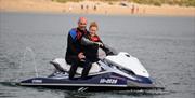 Oxwich Watersports couple on jetski