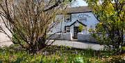 Exterior of Plough and Harrow Murton in the spring with wild garlic in view