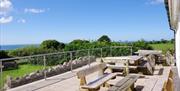 Rhossili Bunkhouse Limited outdoor patio and seating area in sunshine