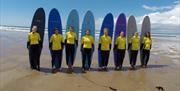 Rip N Rock surf class standing with surfboards