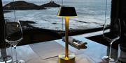 Rok Mumbles dining table with view of lighthouse