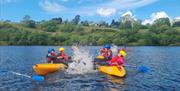 Swansea Adventures kayakers splashing eachoother