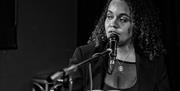 Tŷ Tawe pianist singing into microphone