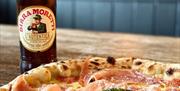 The Pizza Boys fresh baked ham pizza with bottle of beer