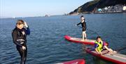 The Sup Hut young paddleboarders in the bay in mumbles
