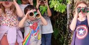 Volcano Theatre children using hand made binoculars