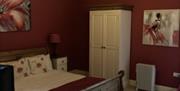 A red themed bedroom at Gower Country Cottages