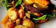 A plate of vegan Burger and Potatoes at Ground Plant Based Coffee Vegan Café